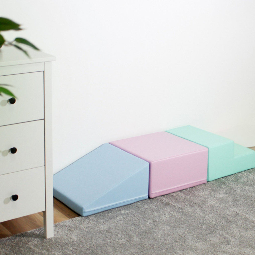 1. IGLU soft pastel foam blocks arranged against a wall in a home setting