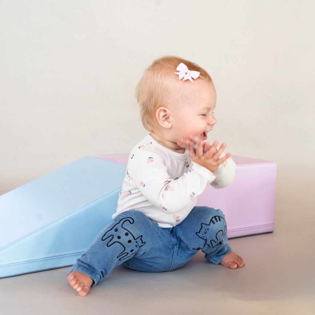 1. Baby sitting next to IGLU soft pastel foam blocks in a studio setting