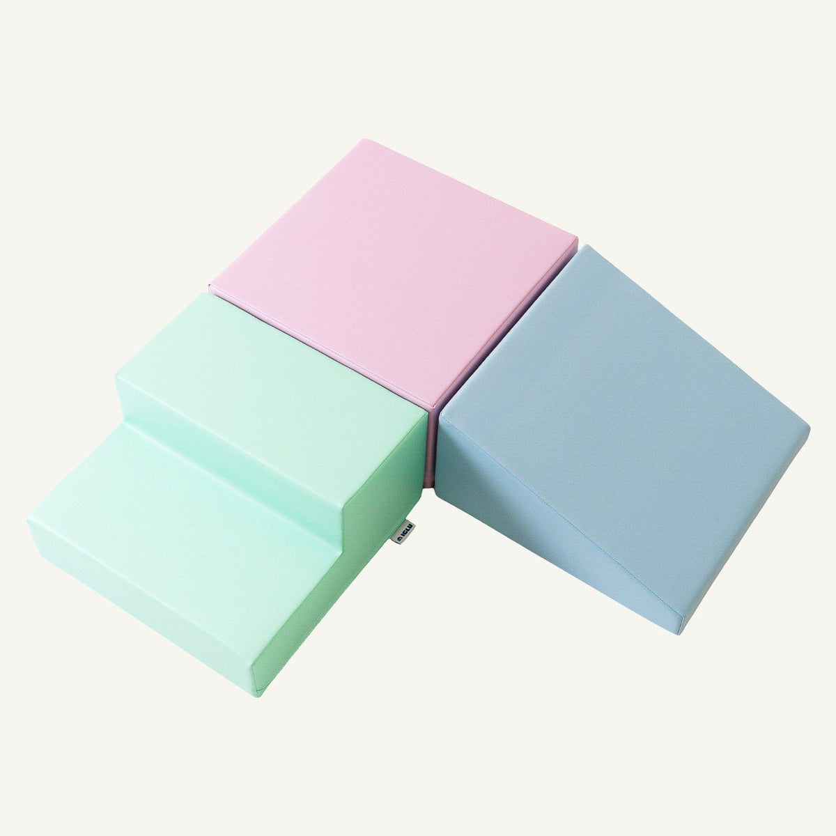 2. Soft pastel foam block set in pink, mint, and blue arranged in a step and slope design on a white background