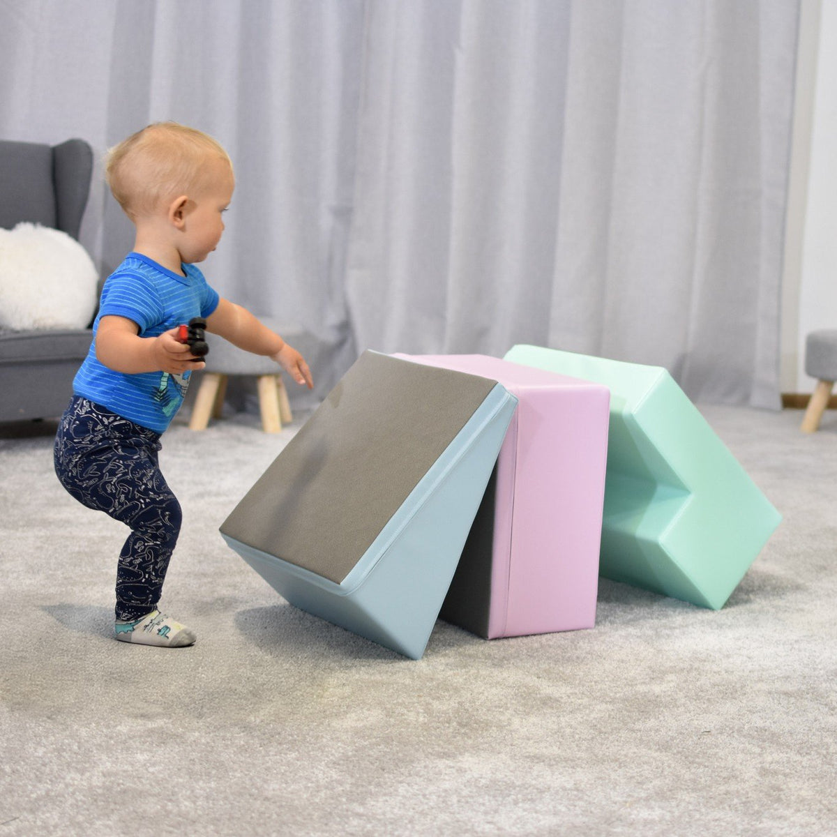 1. Toddler interacting with IGLU soft pastel foam blocks in a playroom