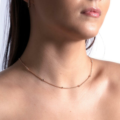 2. Close-up of women's Illumi Doubled S Necklace in rose gold, highlighting delicate chain and zircons