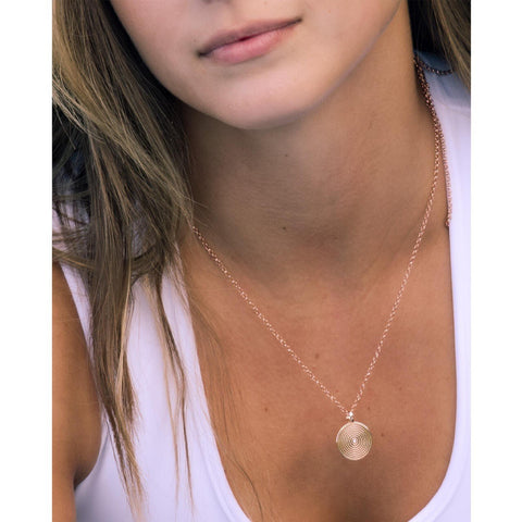 2. Close-up of woman wearing MyaMoon Illumi Infinity Pendant Necklace in rose gold, highlighting zircon centerpiece