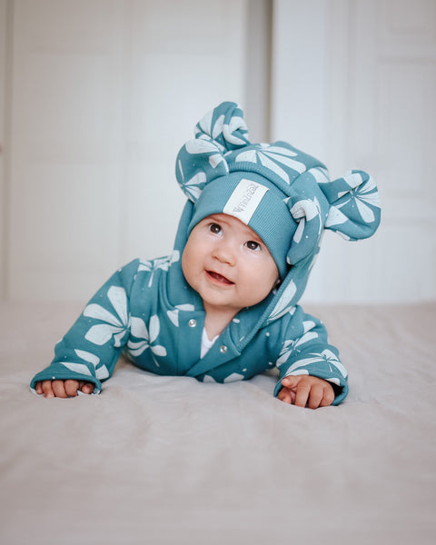3. Baby crawling on bed in green jumpsuit with chestnut leaf design and hood with ears