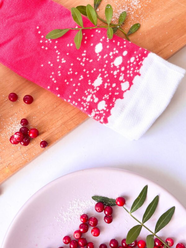 2. Close-up of SEIK cranberry Long Drink Socks with white pattern, surrounded by cranberries