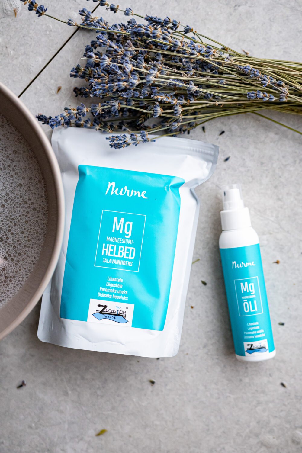 3. Nurme Magnesium Gift Set with oil and flakes next to a bowl and lavender, promoting relaxation
