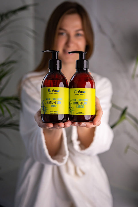 1. Woman holding Nurme Wild Lemongrass hand and body wash and lotion set in lifestyle setting