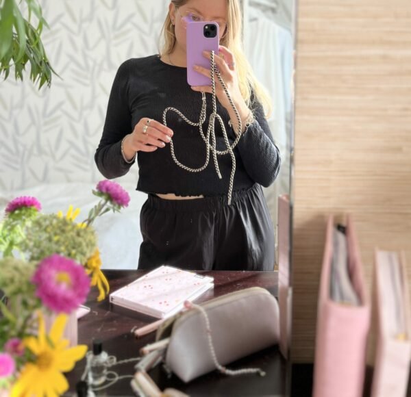 1. Woman using SEIK Universal Phone Strap in Sea Edge design, mirror selfie showing adjustable strap and phone case
