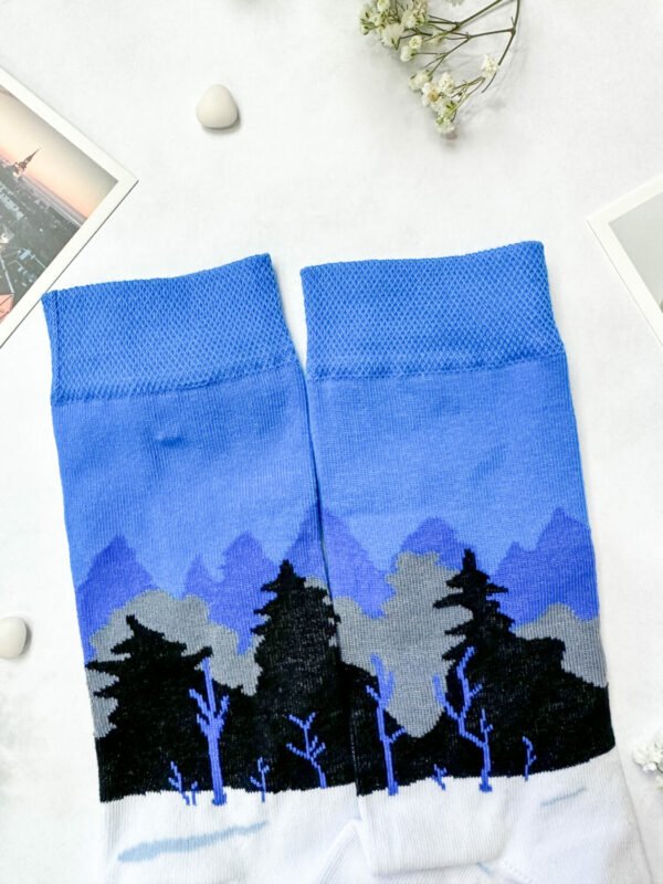 2. Flat lay of SEIK Blue-Black-White Forest socks displaying full Estonian landscape pattern
