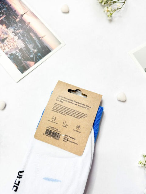 4. Close-up of SEIK Blue-Black-White Forest socks packaging with Estonian landscape design