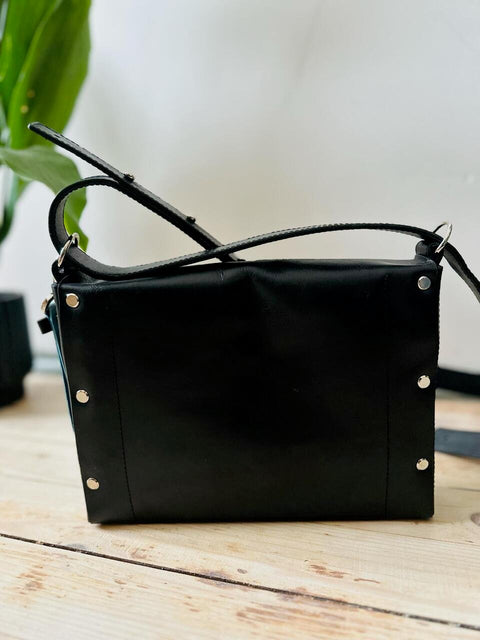 5. Back view of eleriinseim KOKUKA crossbody leather bag in black, showcasing rivet details