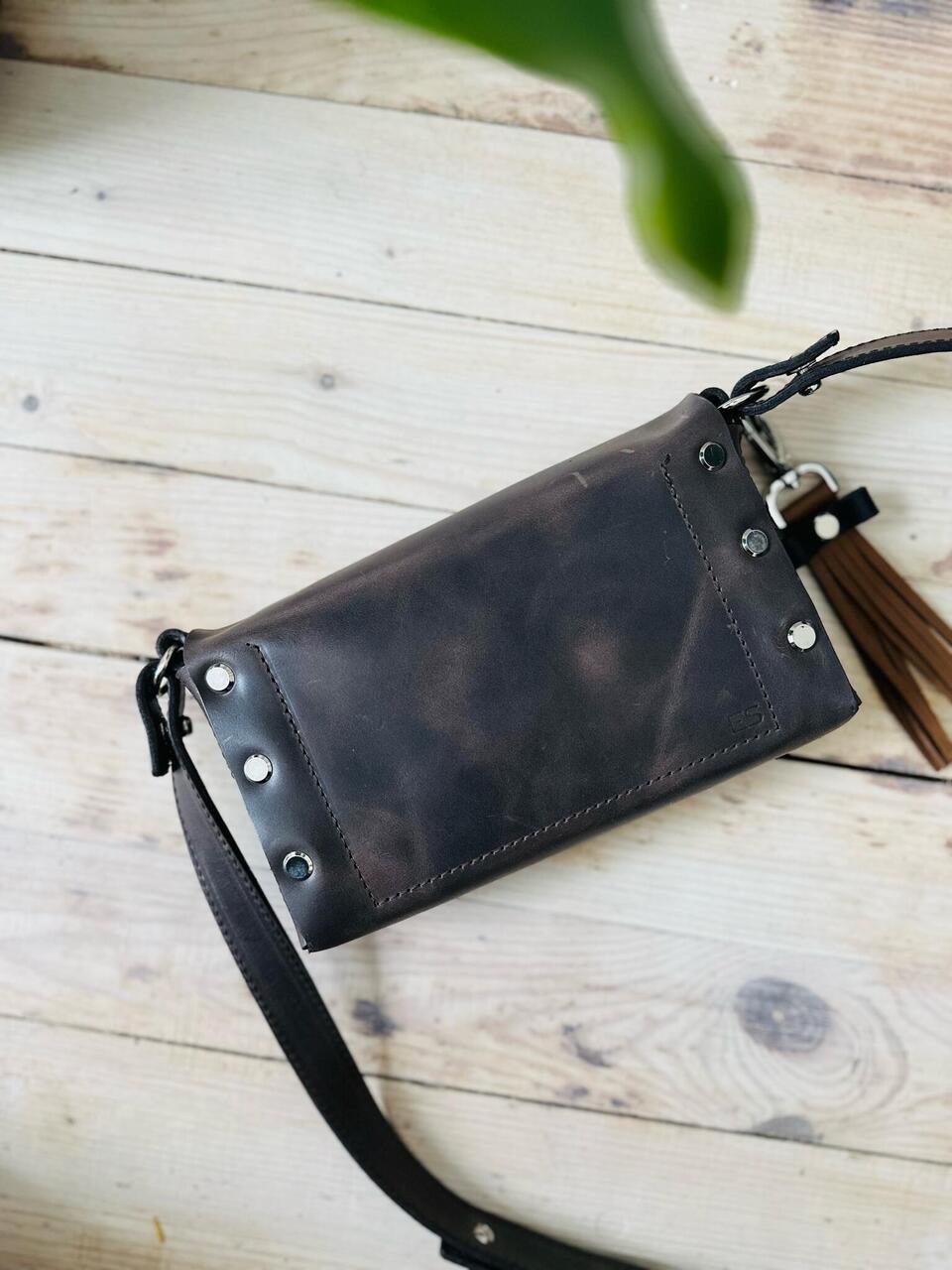 3. Close-up of KOKUKA crossbody leather bag in dark brown, highlighting chrome-tanned cowhide material