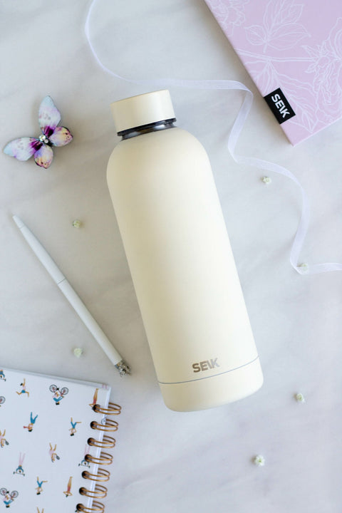 2. SEIK yellow water bottle with matte finish on a desk with a pen and notebook