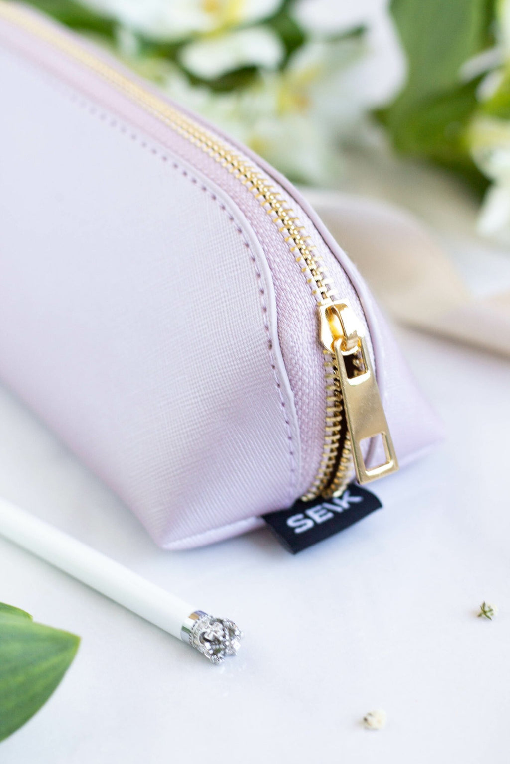 4. Detail of SEIK purple pencil case zipper and brand tag, with decorative elements