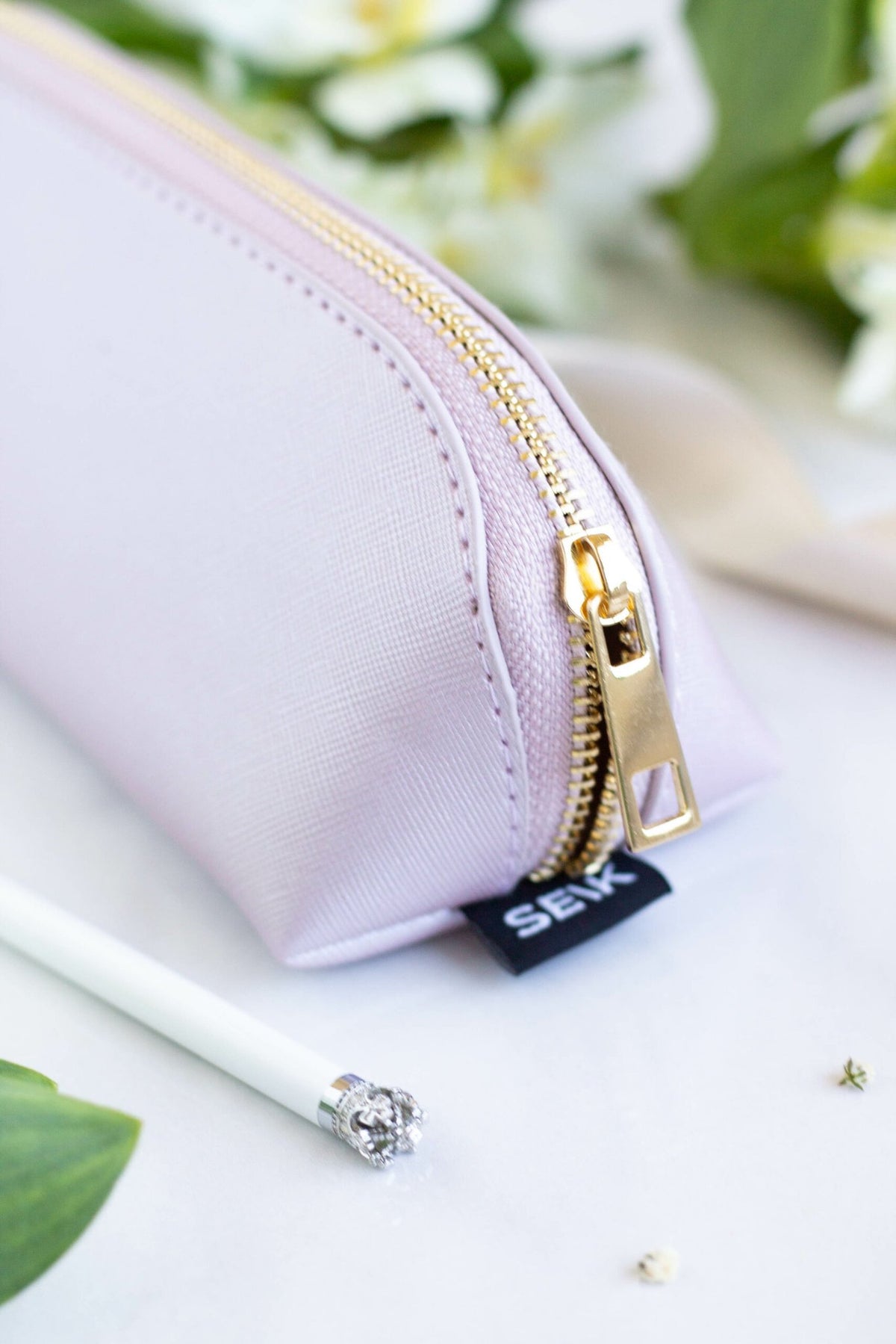 4. Detail of SEIK purple pencil case zipper and brand tag, with decorative elements