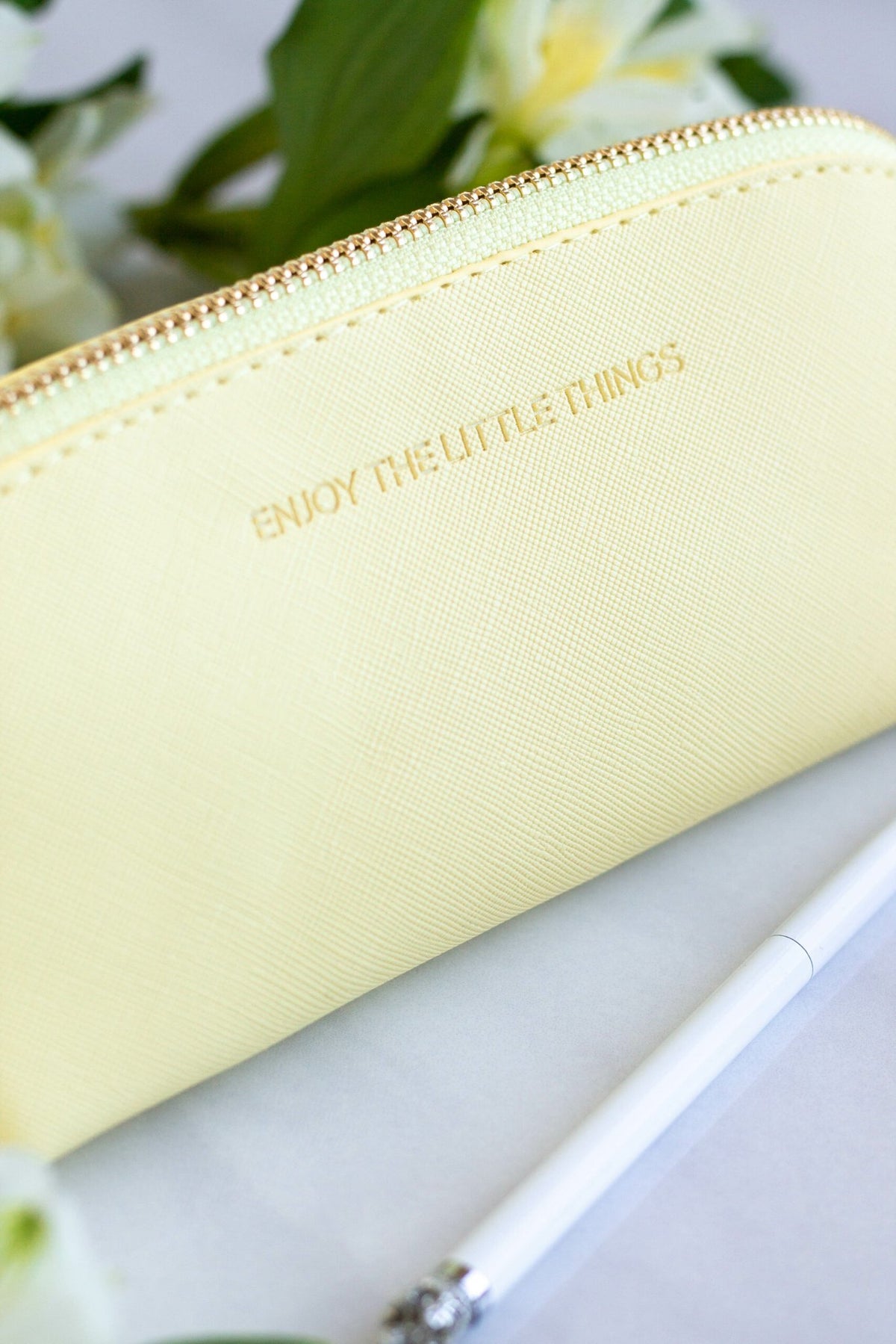 3. Close-up of SEIK Pencil Case Sunshine in yellow with 'Enjoy the little things' text, next to a white pen