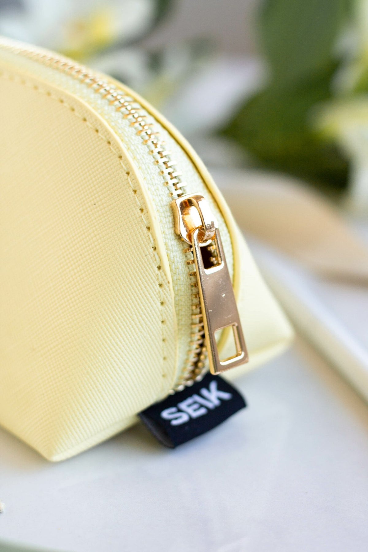 4. Close-up of SEIK Pencil Case Sunshine in yellow, highlighting gold zipper and SEIK branding