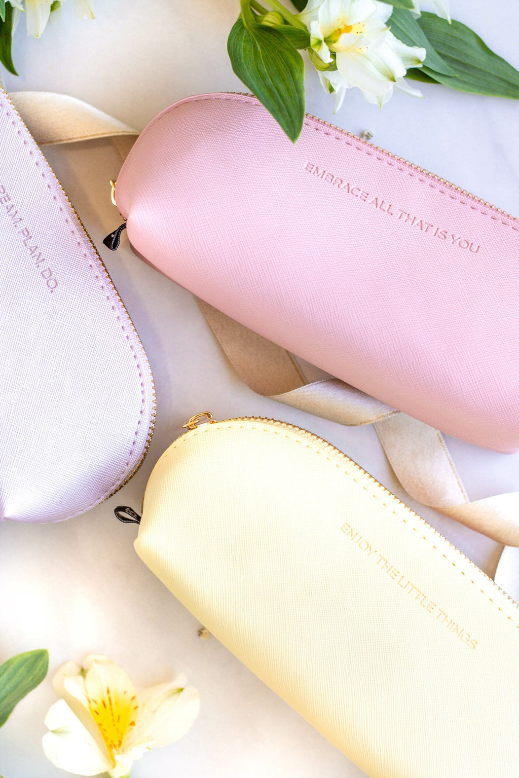 6. Trio of SEIK pencil cases in purple, pink, and yellow with motivational phrases