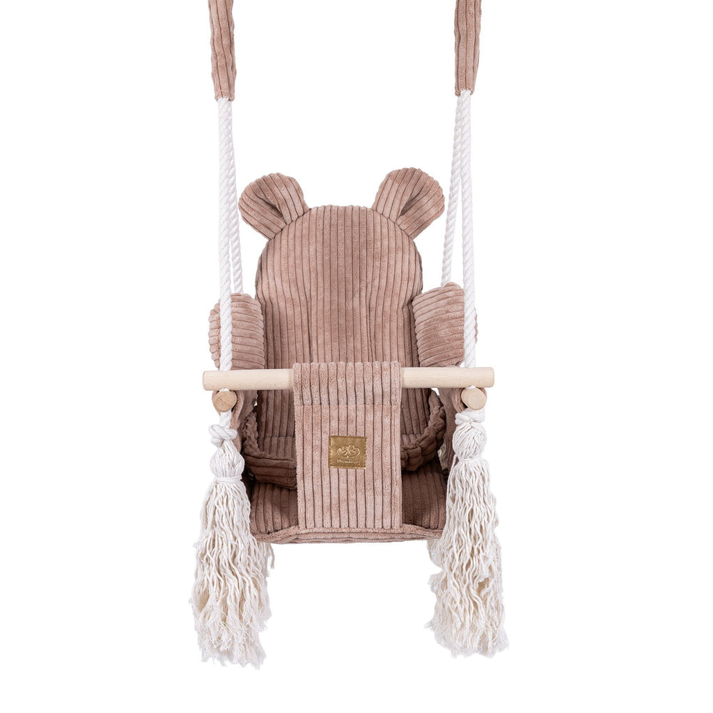 2. Front view of pink powder teddy bear-themed indoor baby swing with corduroy seat and wooden elements, featuring safety belt and fringes.