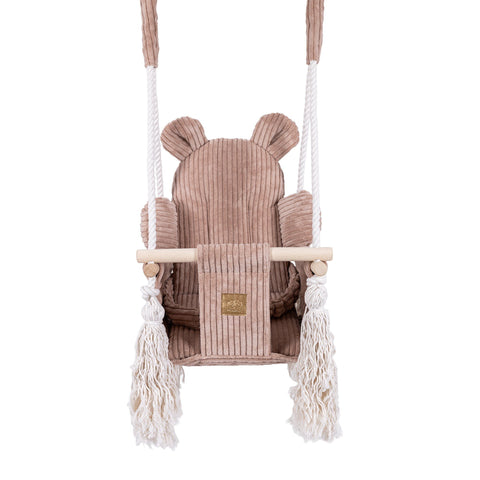 2. Front view of pink powder teddy bear-themed indoor baby swing with corduroy seat and wooden elements, featuring safety belt and fringes.