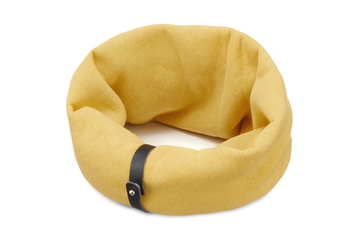 2. Labbvenn Inko neck warmer in gold with black leather strap shown on white background