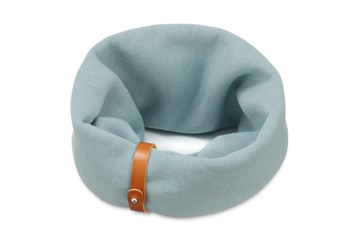 2. Turquoise dog neck warmer with brown leather strap detail on white background