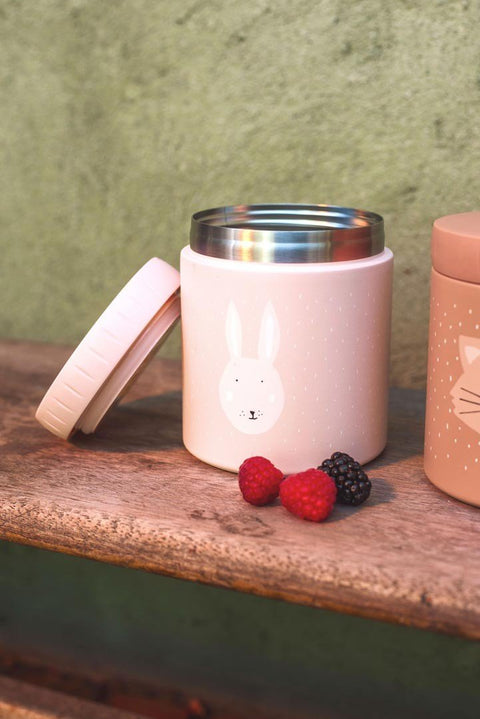 1. Pink insulated lunch pot with rabbit illustration, open lid, and berries on wooden surface outdoors