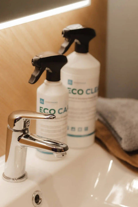 1. GoGoNano EcoCare and EcoClean bottles on bathroom sink with modern faucet, highlighting eco-friendly cleaning solutions