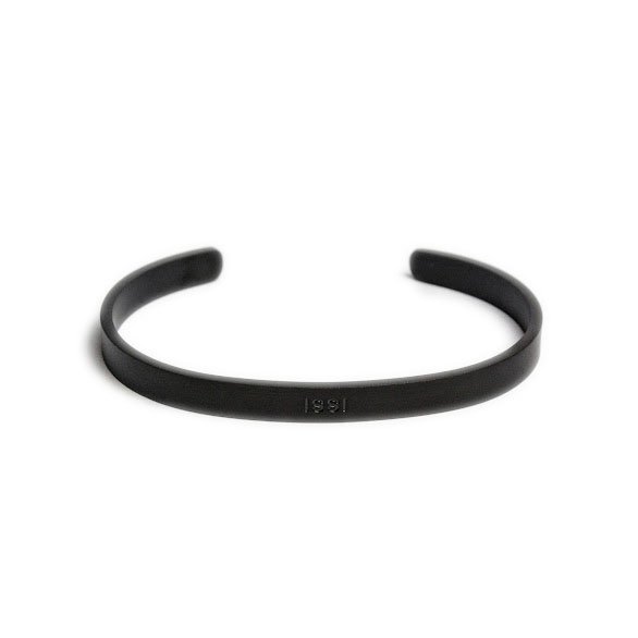 2. Matte black Olla men's bracelet with ISSI engraving, shown on white background highlighting open cuff design