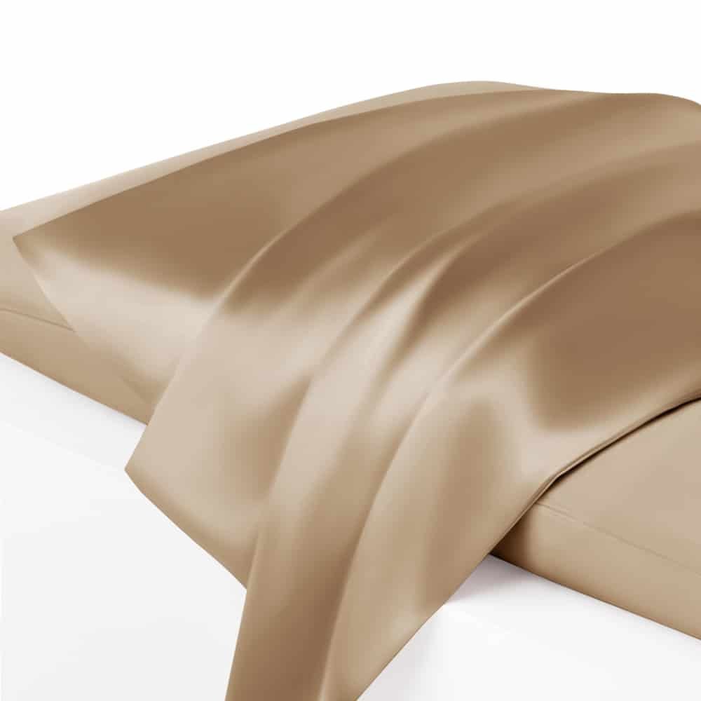 17. Close-up of cappuccino silk pillowcase on bed, showcasing smooth texture