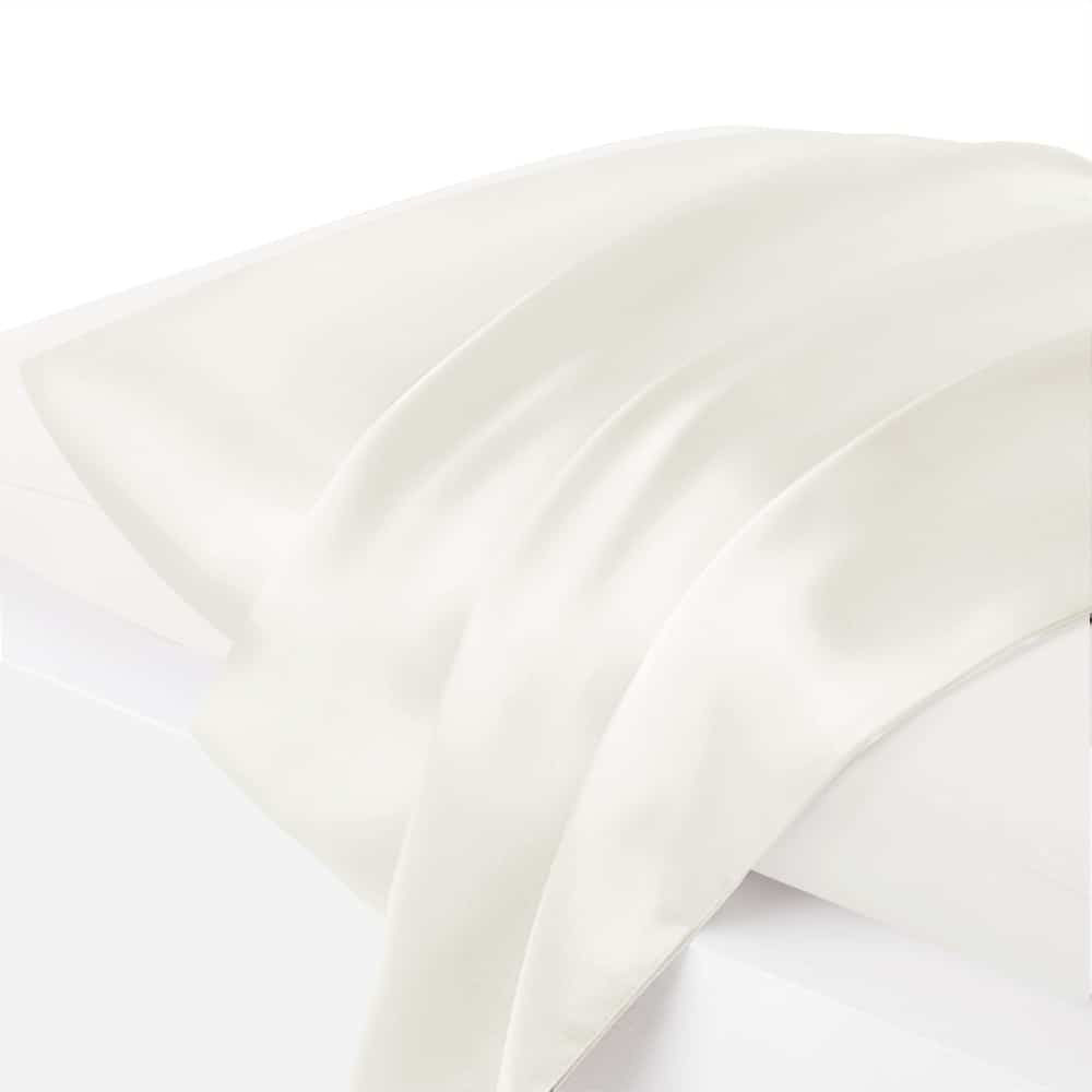 27. Close-up of white silk pillowcase on bed, showcasing smooth texture