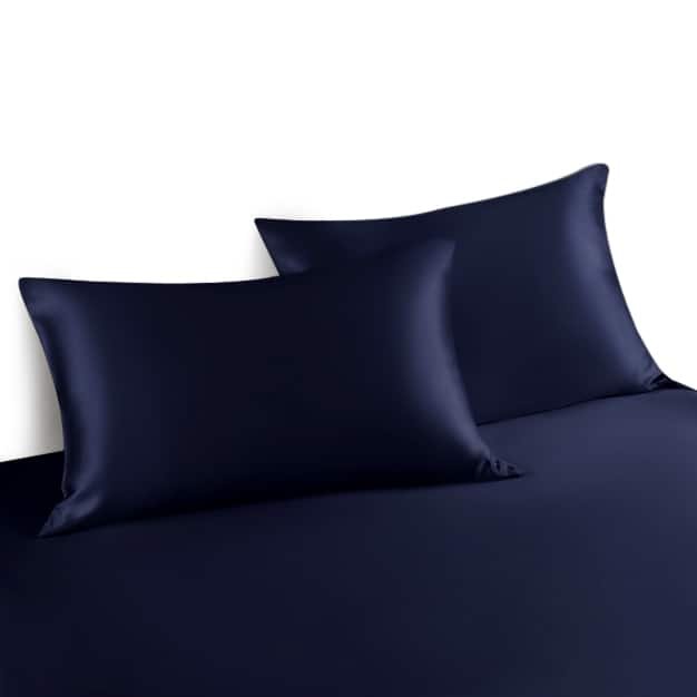 4. Two navy blue silk pillowcases on matching bedspread, showcasing elegant design