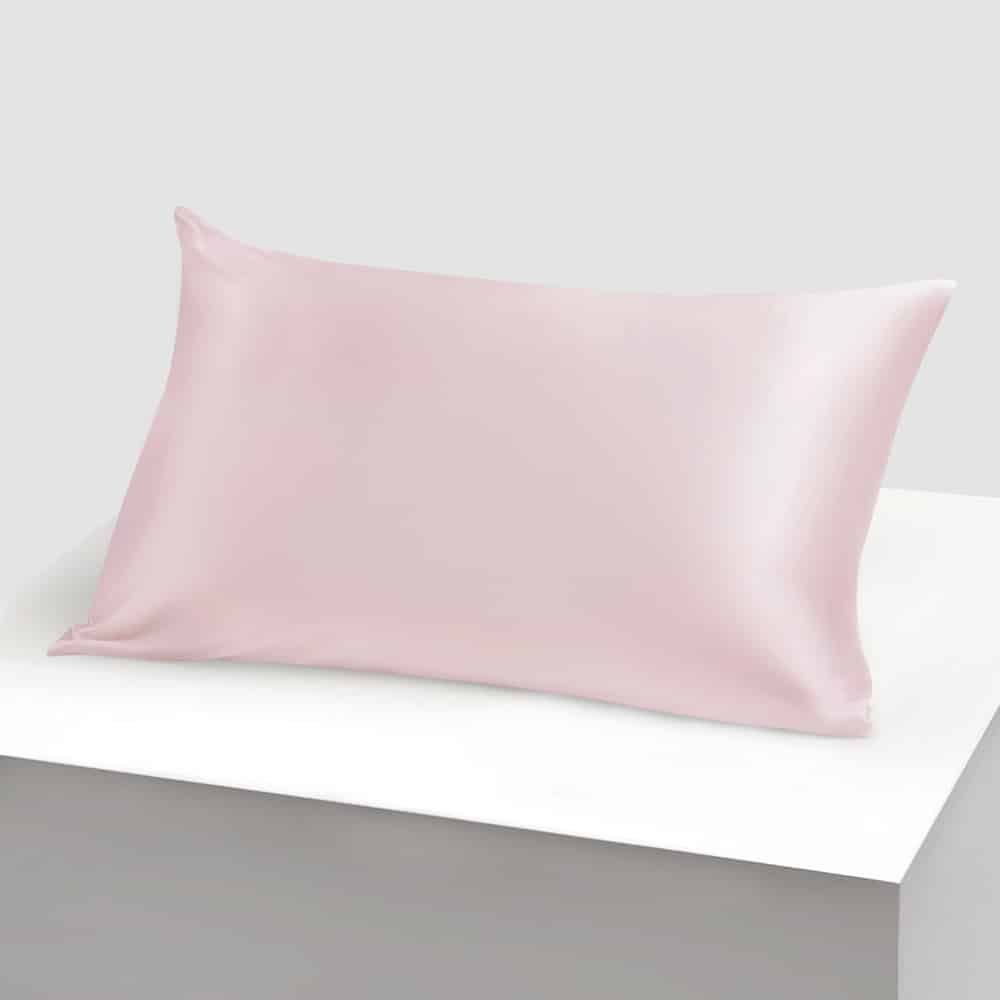 11. Single light pink silk pillowcase on white background, highlighting elegant design