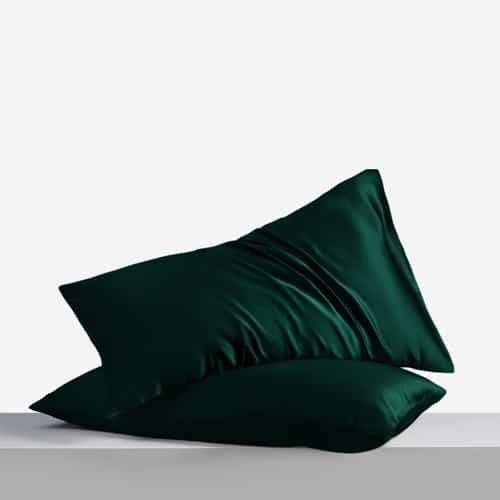 21. Pair of green Mulberry silk pillowcases on a grey surface, emphasizing elegance