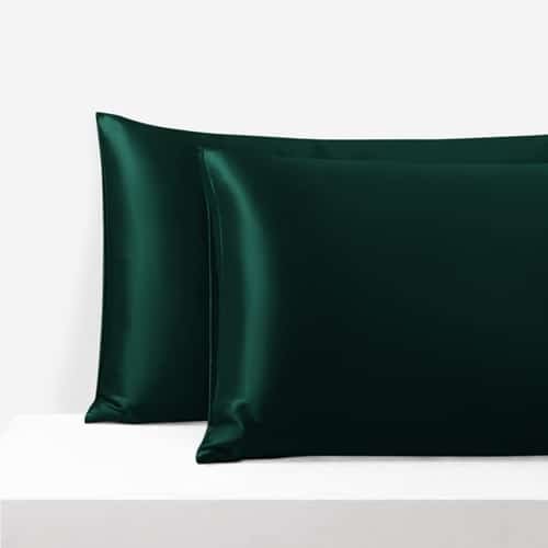 20. Pair of green Mulberry silk pillowcases on a white surface, highlighting luxurious texture