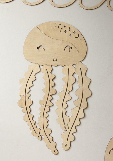 2. Wooden jellyfish wall decoration with smiling face and wavy tentacles on white background