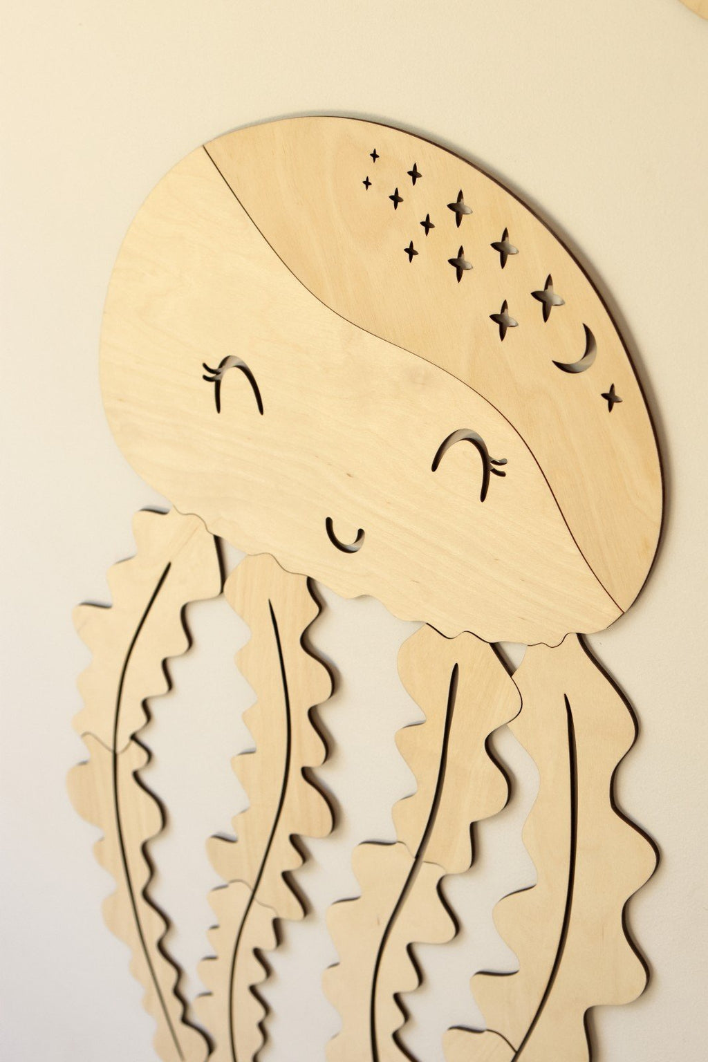 5. Close-up of wooden jellyfish wall decoration showing smooth sanded finish and star details
