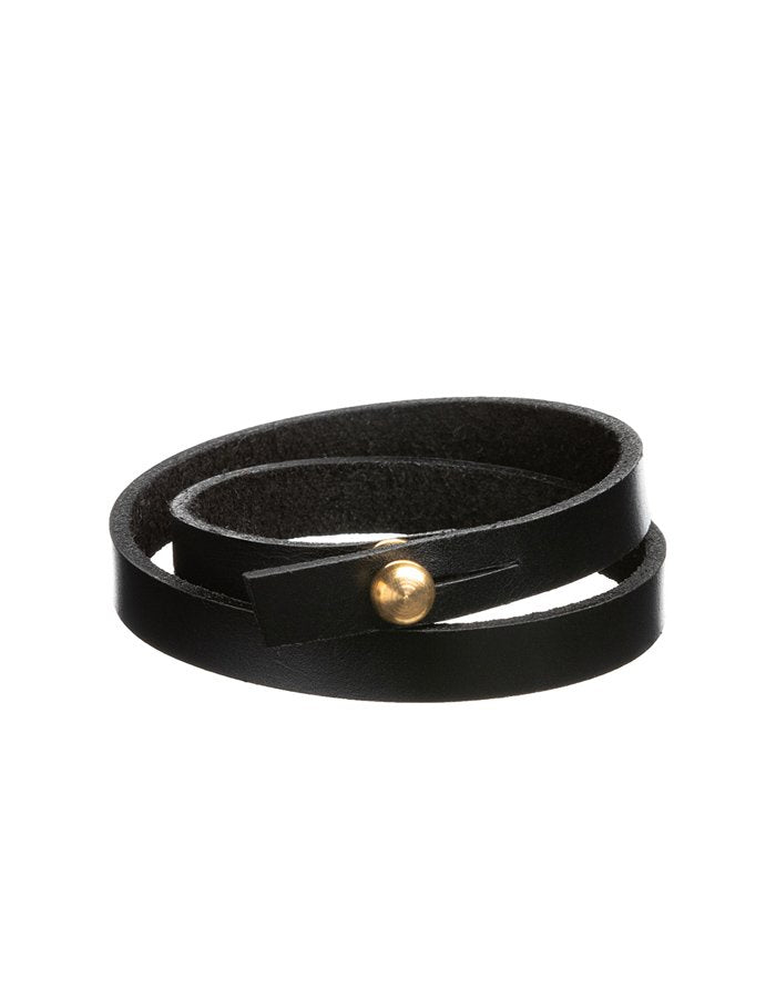 3. Black leather wristband by Stella Soomlais with gold screw button, shown in studio lighting highlighting double wrap design
