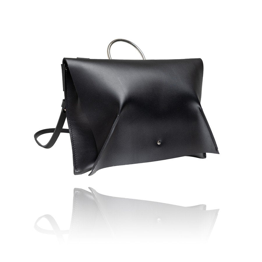 3. Side view of black leather Handbag Kamila by PYKOK with magnetic closure, studio shot