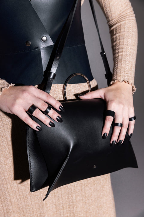 1. Women's Handbag Kamila by PYKOK in black leather, styled with adjustable strap, shown in lifestyle setting