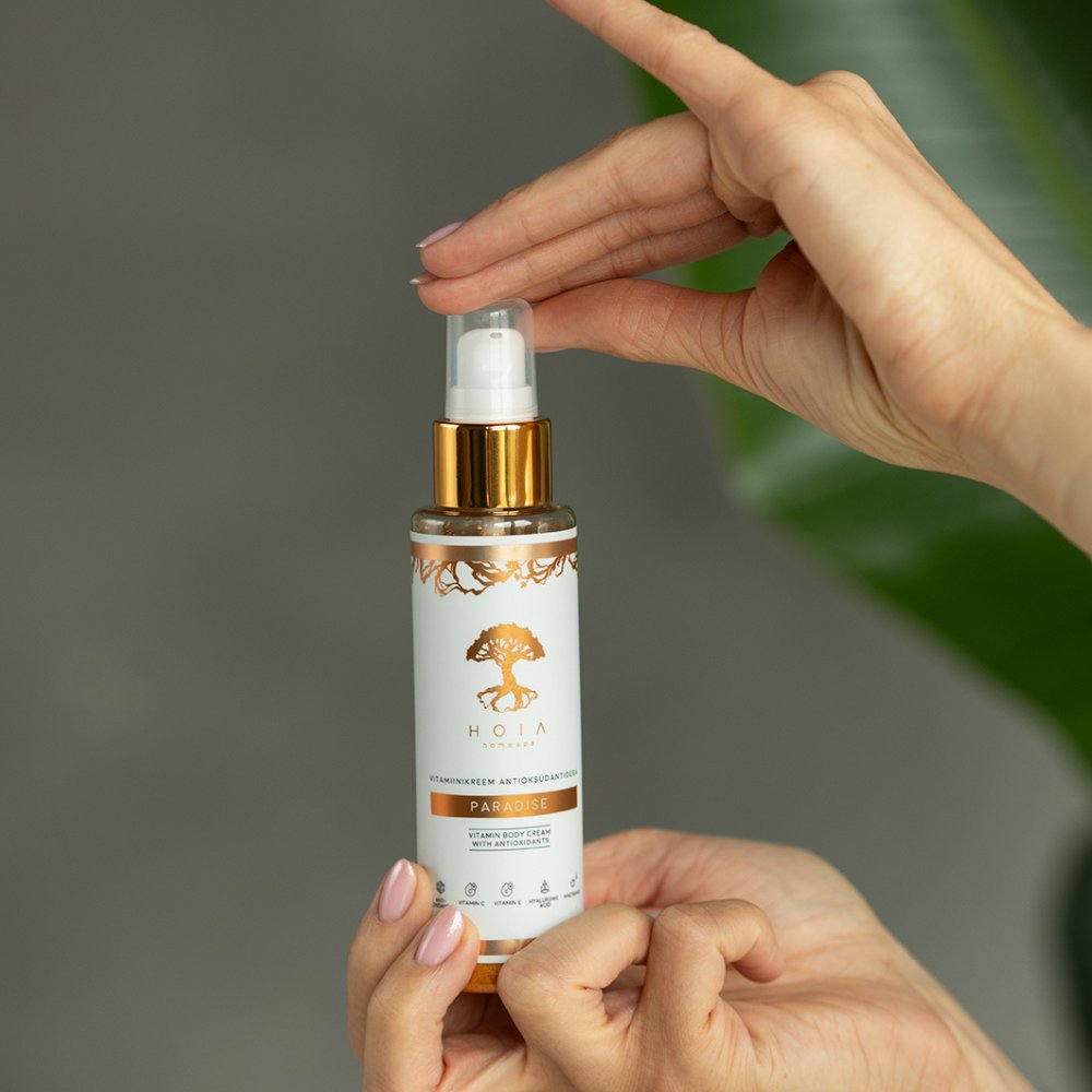 1. HOIA homespa Vitamin Body Cream Paradise, 100 ml, held by a woman's hands, showcasing pump design for easy application