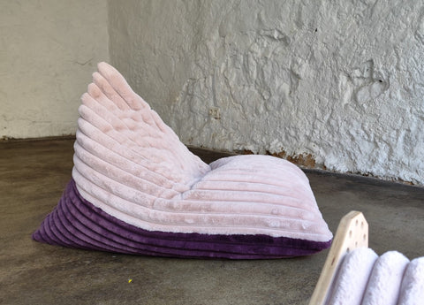2. Luula kids bean bag chair in berry and rose mousse tones on a concrete floor, showcasing its ribbed plush texture and supportive design