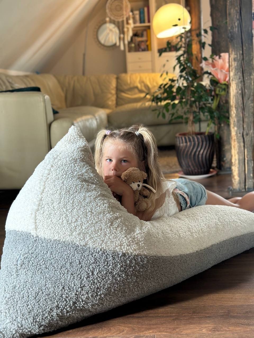 1. Girl relaxing on Luula Kids Bean Bag Chair in two-tone sherpa, looking out window
