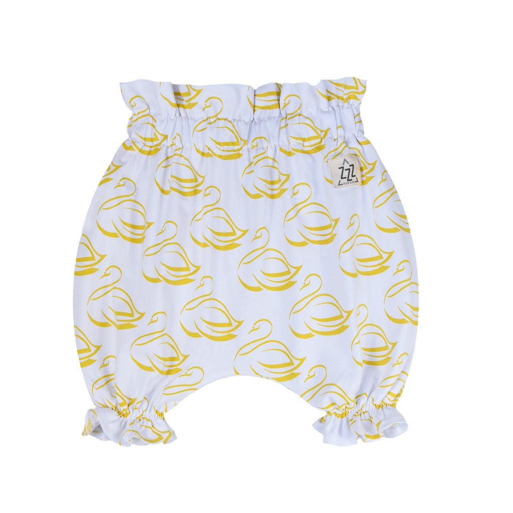 3. Studio shot of white bloomers with golden-yellow swan print, ruffled leg openings, and elastic waistband on white background