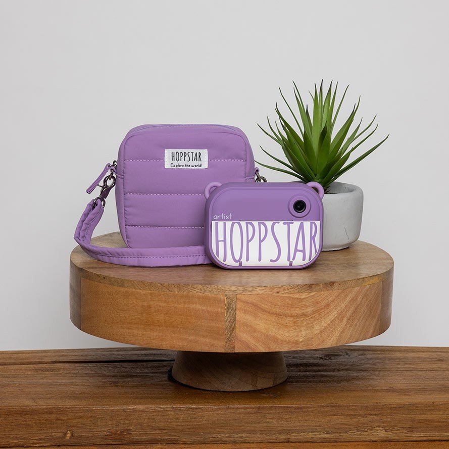 4. Purple Hoppstar camera with matching case on wooden stand with plant