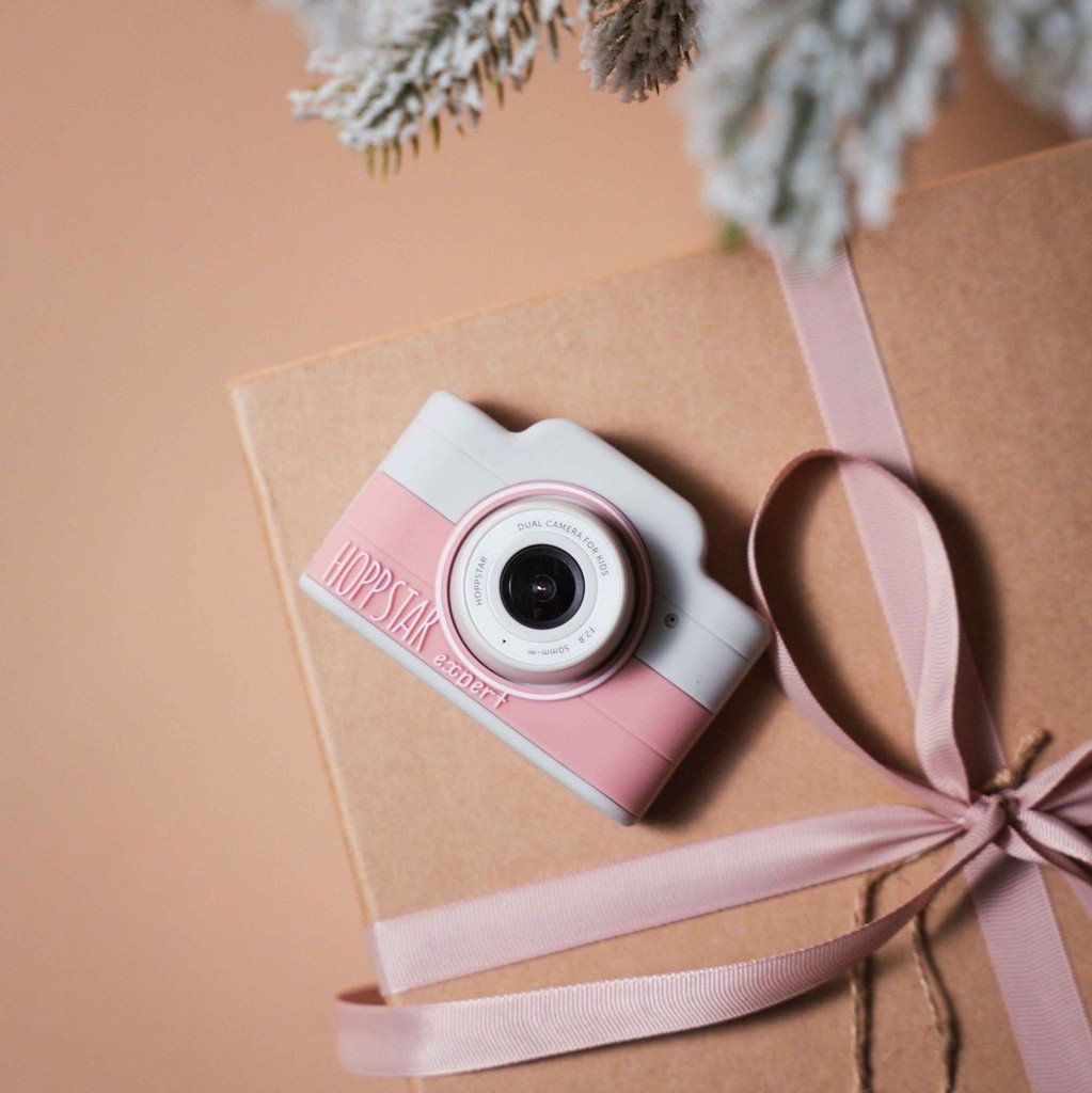 3. Pink Hoppstar Expert camera on gift-wrapped surface with ribbon