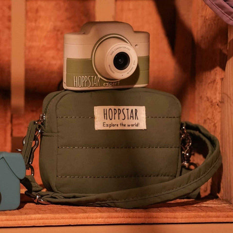 1. Green Hoppstar Expert camera on shelf with matching bag, warm lighting