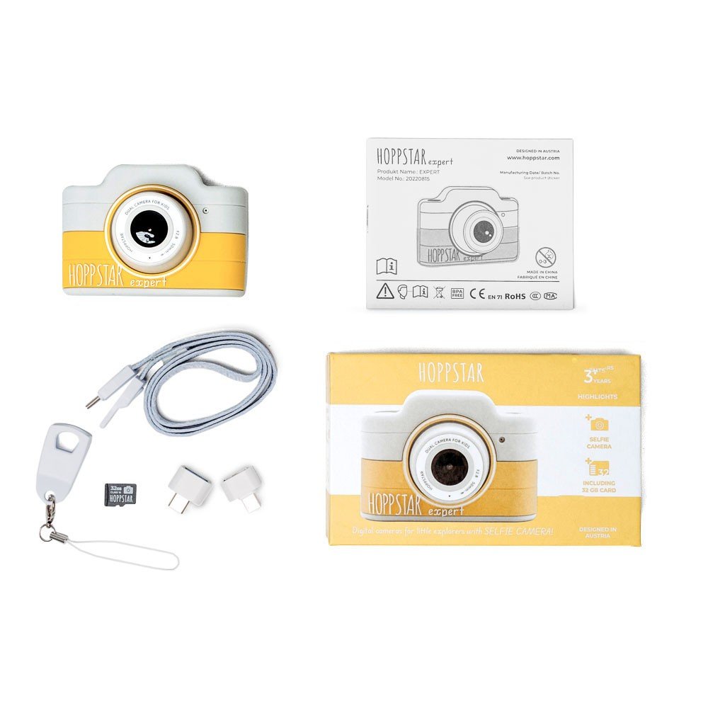 4. Flat lay of yellow Hoppstar Expert children's camera with packaging and accessories