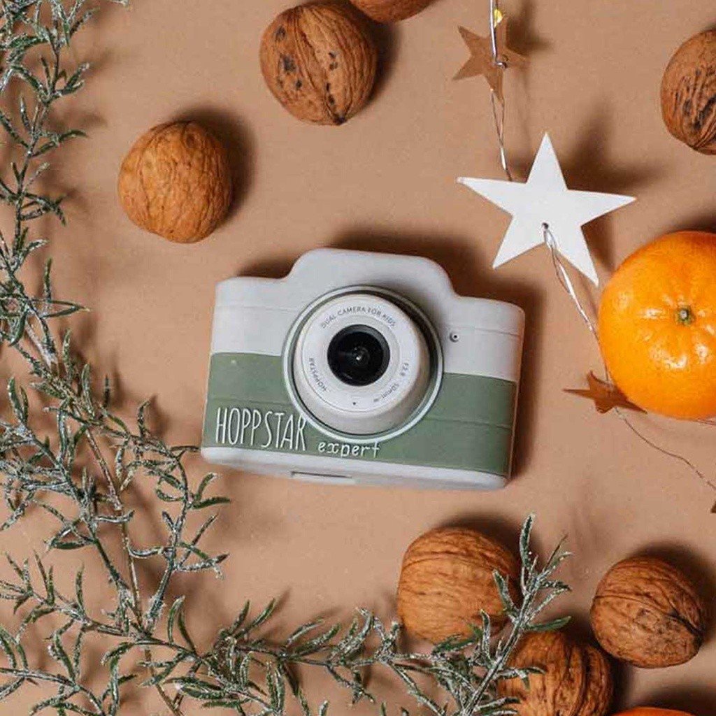 3. Green Hoppstar Expert camera surrounded by festive decorations on wooden surface