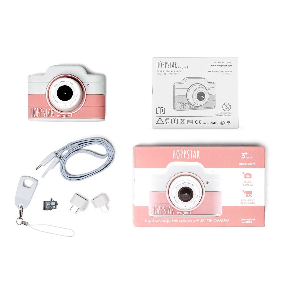 4. Flat lay of pink Hoppstar Expert children's camera with packaging and accessories