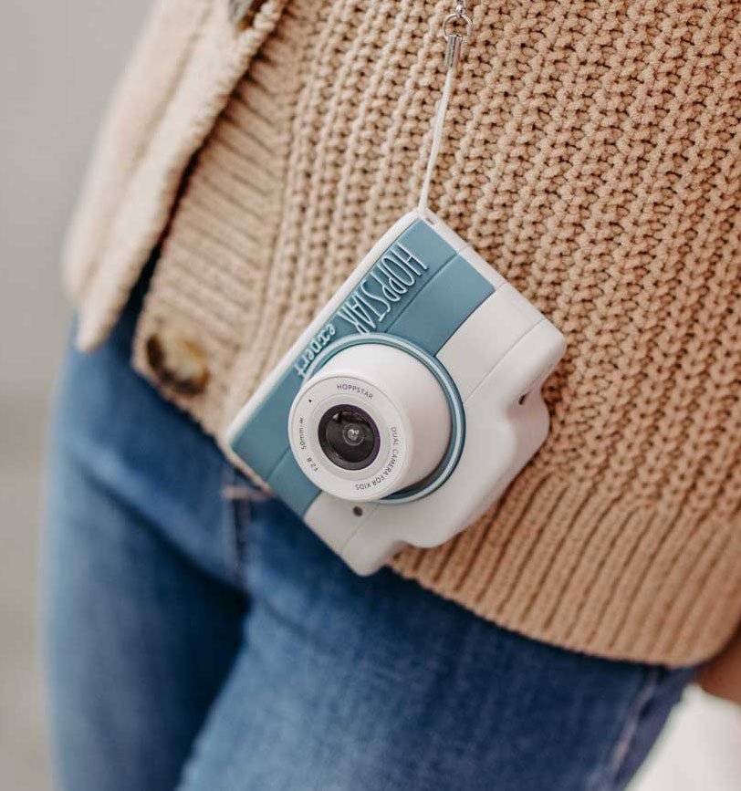 1. Blue Hoppstar Expert camera hanging from child's sweater, close-up